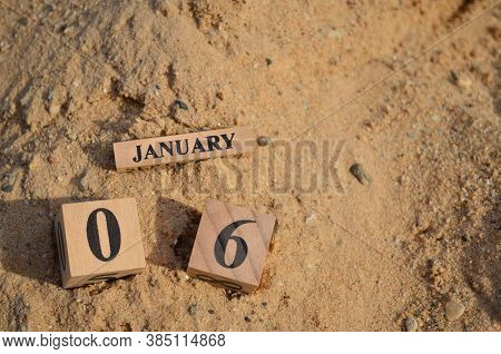 January 6, Number Cube With A Sand Background.