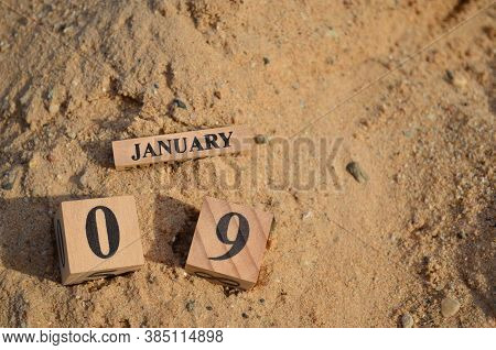 January 9, Number Cube With A Sand Background.