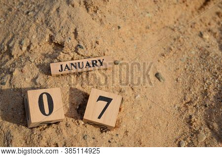 January 7, Number Cube With A Sand Background.