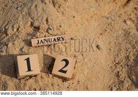 January 12, Number Cube With A Sand Background.