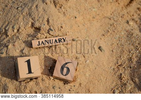 January 16, Number Cube With A Sand Background.