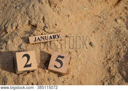 January 25, Number Cube With A Sand Background.