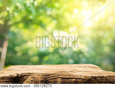 Real Wood Table Top Texture On Blur Leaf Tree Garden Background.for Create Product Display Or Design
