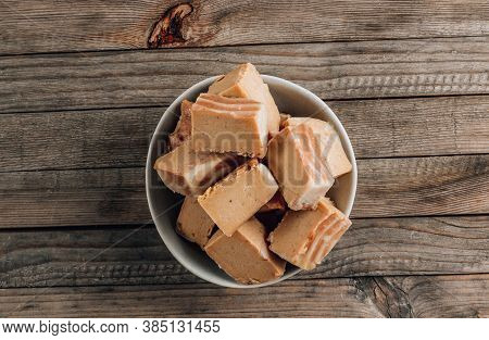 Raw Vegan Peanut Butter Fudge On A Rustic Wooden Background.