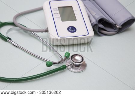 Stethophonendoscope And Blood Pressure Meter On A Green Background.concept Of Medical Services And I