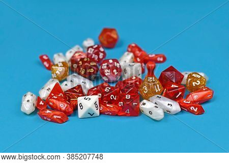 Different Red, Golden And White Roleplaying Game Dices On Blue Background