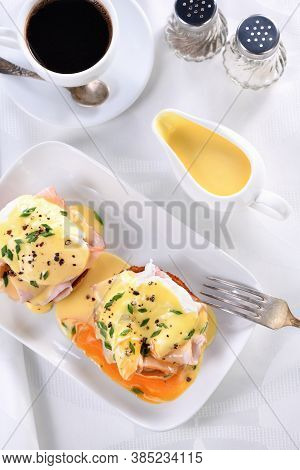 Hollandaise Butter Sauce In A Gravy Boat For Breakfast Served With Eggs Benedict- Fried English Bun,