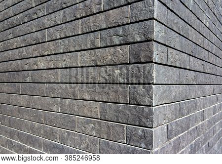 The Corner Of The House Is Made Of Gray Tiles That Imitate Brickwork. Modern Finishing Material. The