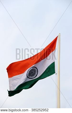 Tri Color Of Indian Flag, Orange White And Green Color With Blue Dhamma Wheel At Center On Sky Backg