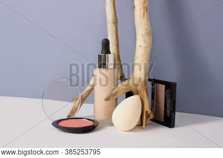 Set Of Makeup Professional Products On Blue Background. Composition With Foundation, Eyeshadows, Blu