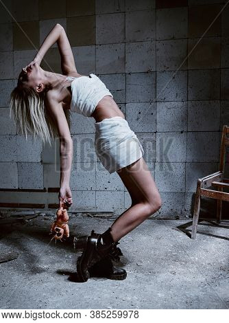 Strange Insane Girl With Creepy Ugly Doll In Forsaken Place (madhouse). Crazy Young Woman (freak) Dr
