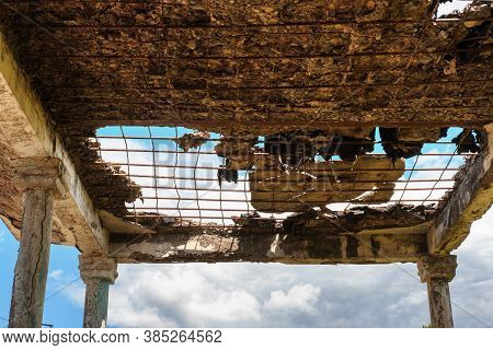 View Of A Blue Cloudy Sky Through The Ruined Ceiling And Roof