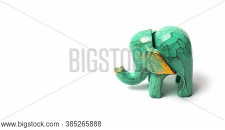 Figurine Of A Green Wooden Elephant With Gilding Isolated On White Background. Decorative Figurine O