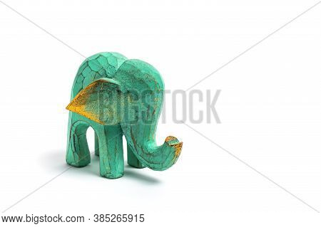 Figurine Of A Green Wooden Elephant With Gilding Isolated On White Background. Decorative Figurine O