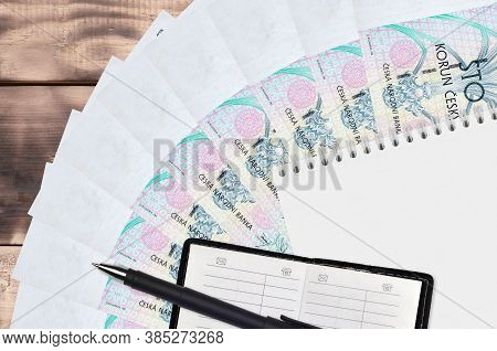 100 Czech Korun Bills Fan And Notepad With Contact Book And Black Pen. Concept Of Financial Planning
