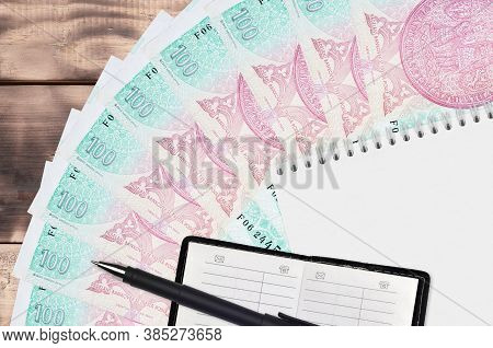 100 Czech Korun Bills Fan And Notepad With Contact Book And Black Pen. Concept Of Financial Planning