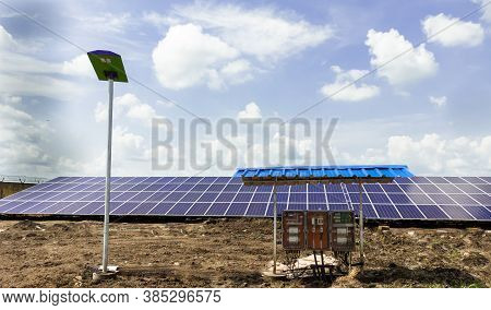 Row Of Installed Photovoltaic Solar Panels Or Modules, Solar Street Light And String Combiner Box, S