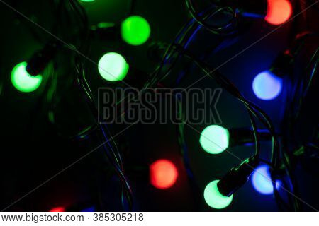 Christmas Color Garland At Night.color Festoon On Black Background