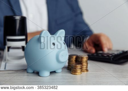 Piggy Bank And Coins On Desk In Office. Save Money And Management Financial Concept