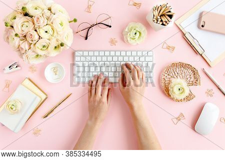 Stylized, Pink Womens Home Office Desk. Workspace With Female Hands, Computer, Bouquet Ranunculus An