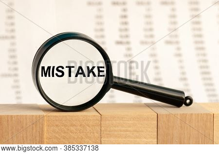 A Magnifying Glass Against Columns Of Numbers Background Increases The Word Mistake