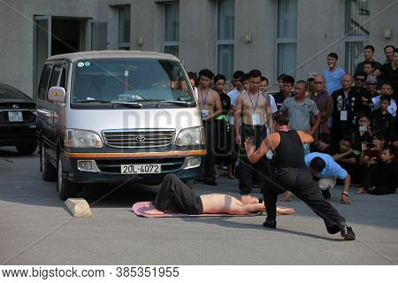 Hanoi, Vietnam - Aug 9, 2015: Vietnamese pugilists in traditional costume doing a performance of mar