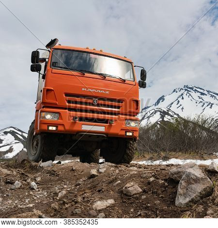 Russian Off-road Expedition Passenger Truck Kamaz On Mountain Road On Background Of Volcano On Sunny