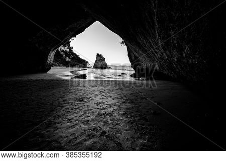 Scenic View Through Natural Arch Of Cathedral Cove On Coromandel Peninsula New Zealand.