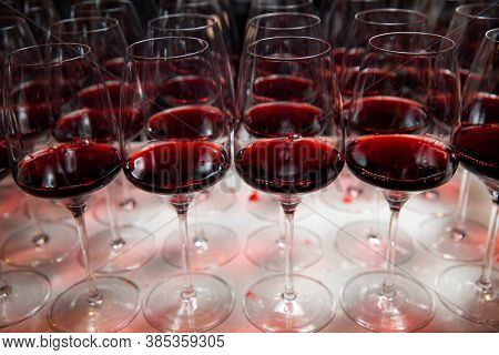 Glasses Of Red Wine Are On The Table, Ready To Serve.