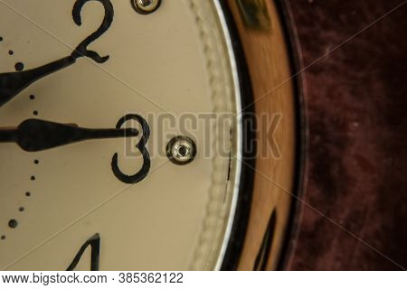 Table Clock Brown With A White Dial Close-up Photo.