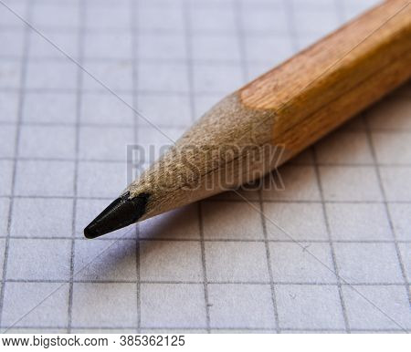 Yellow Sharpened Pencil On A Piece Of Paper In A Cage.