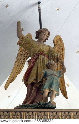 RADOBOJ, CROATIA - SEPTEMBER 21, 2014: Guardian angel, statue on the altar of St Joseph at Holy Trinity Church in Radoboj, Croatia