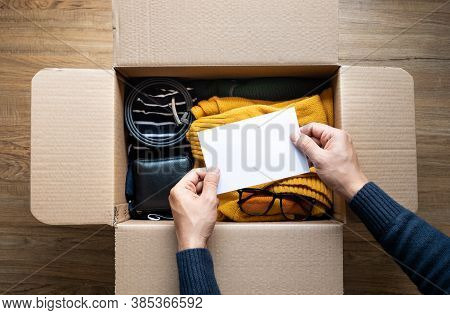 Donation Concepts With Person Holding White Card On Accessories Clothing In Box.giving And Sharing W