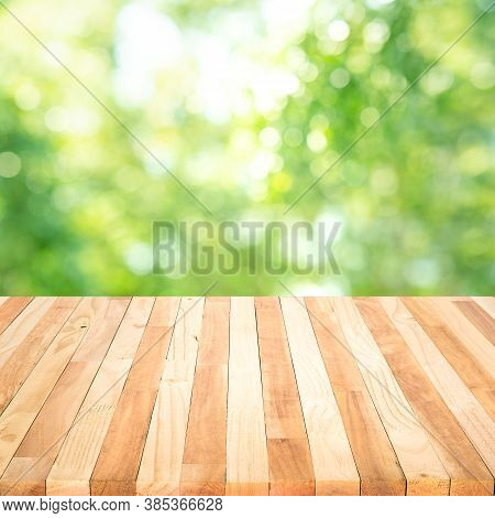 Real Wood Table Top Texture On Blur Leaf Tree Garden Background.for Create Product Display Or Design