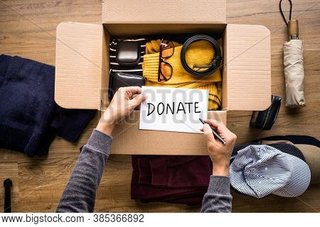 Donation Concepts With Person Writing Text Donate Message On Accessories In Box.giving And Sharing W