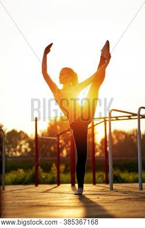 Stretching Fit Or Dancer Woman Doing Vertical Split, Twine In Workout Sports Ground. Dancer Silhouet