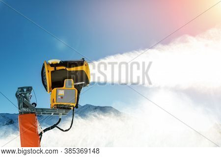 Operating Artificial Snow Cannon Near Piste Making Snowy Powder.ski Lift Ropeway On Hilghland Alpine