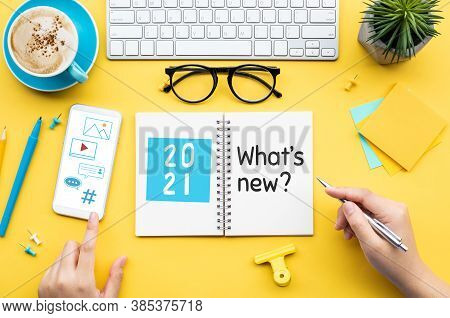 2021 What's New ? Or Trendy Concepts With Young Person Writing Text On Notepaper And Office Accessor