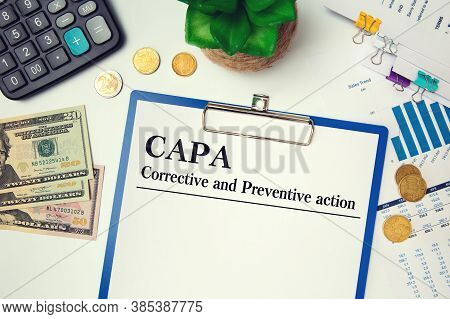 Paper With Corrective And Preventive Action Capa On The Table, Calculator And Glasses
