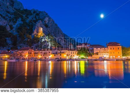 Night View Of The Mirabella Tower With The Moon And Reflection. Croatia.