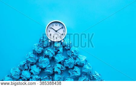 Timing And Thinking Idea With Paper Crumpled Ball And White Clock. Business Performance