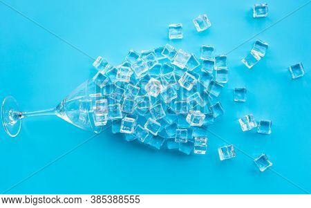 Ice Cube With Glass On Blue Background.cold Drink Or Refreshing Concepts.