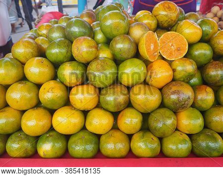 Pile Of Tangerines For Sale In The Market. Full Frame Photo. Concept Of Fruits Healthy