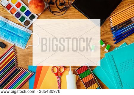 Top View Of School Stationery, Medical Mask. Back To School And Protection From Coronavirus.