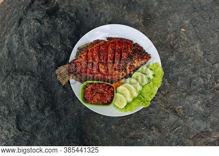 Delicious Grilled Tilapia (nila Bakar) From Indonesia With Rice, Tempeh, Vegetables, And Chilli Sauc
