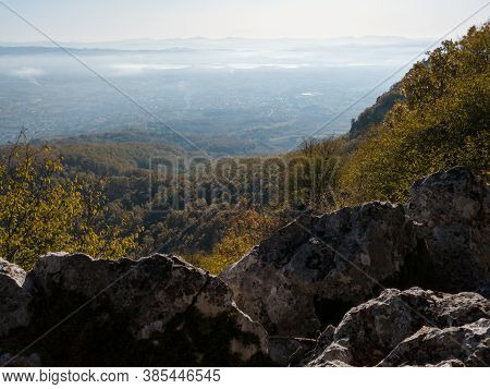 Scenic View From Kozara Mountain To The Valley Filled With Fog And Smoke During A Sunny Day.
