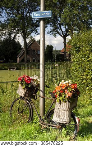 Bicycle Decorated With Flowers And Posted Against A Lantern Pole In The Dutch Village Geervliet