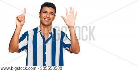 Young arab man wearing casual clothes showing and pointing up with fingers number six while smiling confident and happy. 