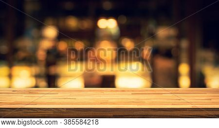 Wood Texture Table Top (counter Bar) With Blur Light Gold Bokeh In Cafe,restaurant Background.for Mo