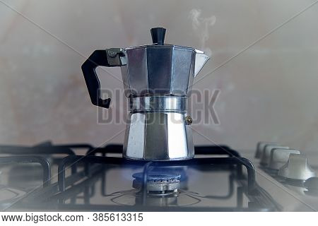 An Italian Coffee Maker On The Gas Stove. The Process Of Making Coffee